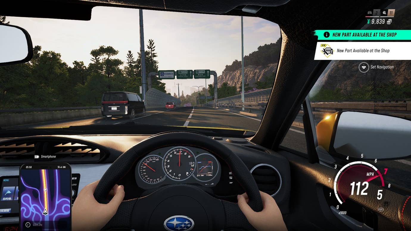 The player views their car from the cockpit perspective, gripping the wheel.